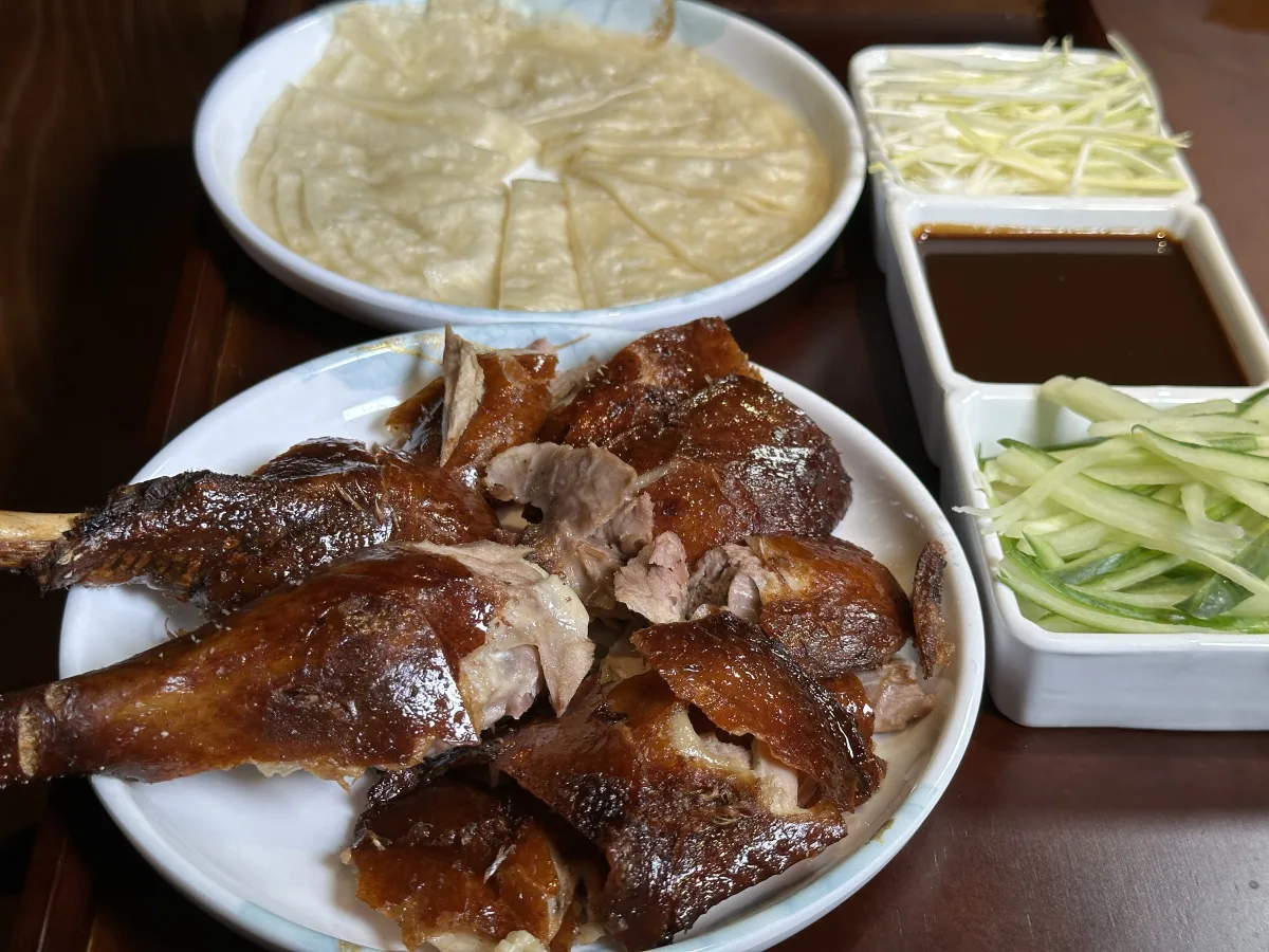 Crispy Peking Duck sliced with pancakes and scallions